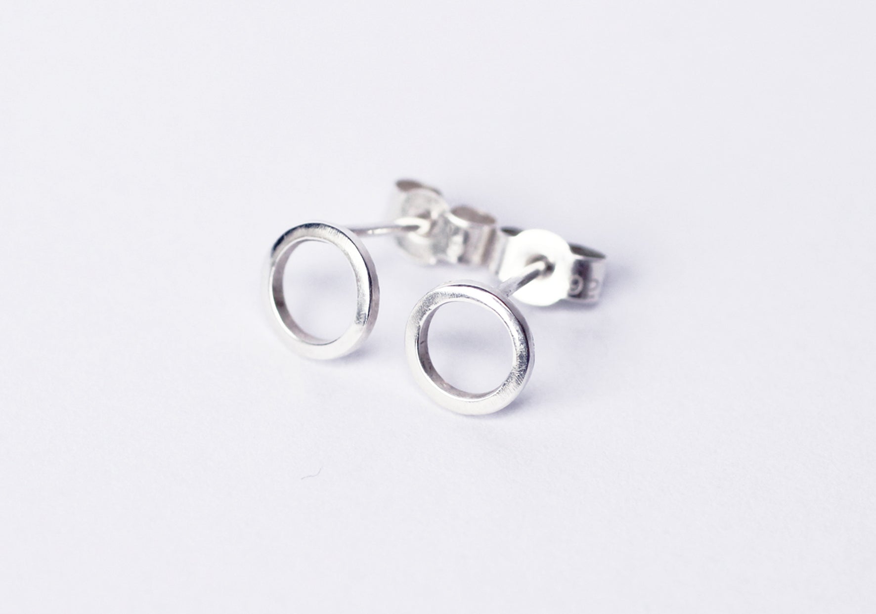 Continuum-silver-circle-stud-earrings-flatlay