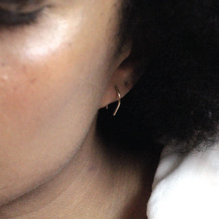 Hook earrings in gold shown on model