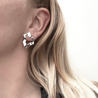 Close-up of woman wearing STORM Earrings - sculptural solid silver earrings by Marie Beatrice Gade