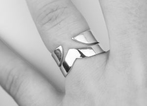 Adelphi-and-Thor-stackable-v-shaped-silver-rings-Marie-Beatrice-Gade-on-hand-black-and-white