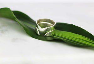 Adelphi-and-Thor-v-shaped-silver-rings-stacked-Marie-Beatrice-Gade-on-leaf