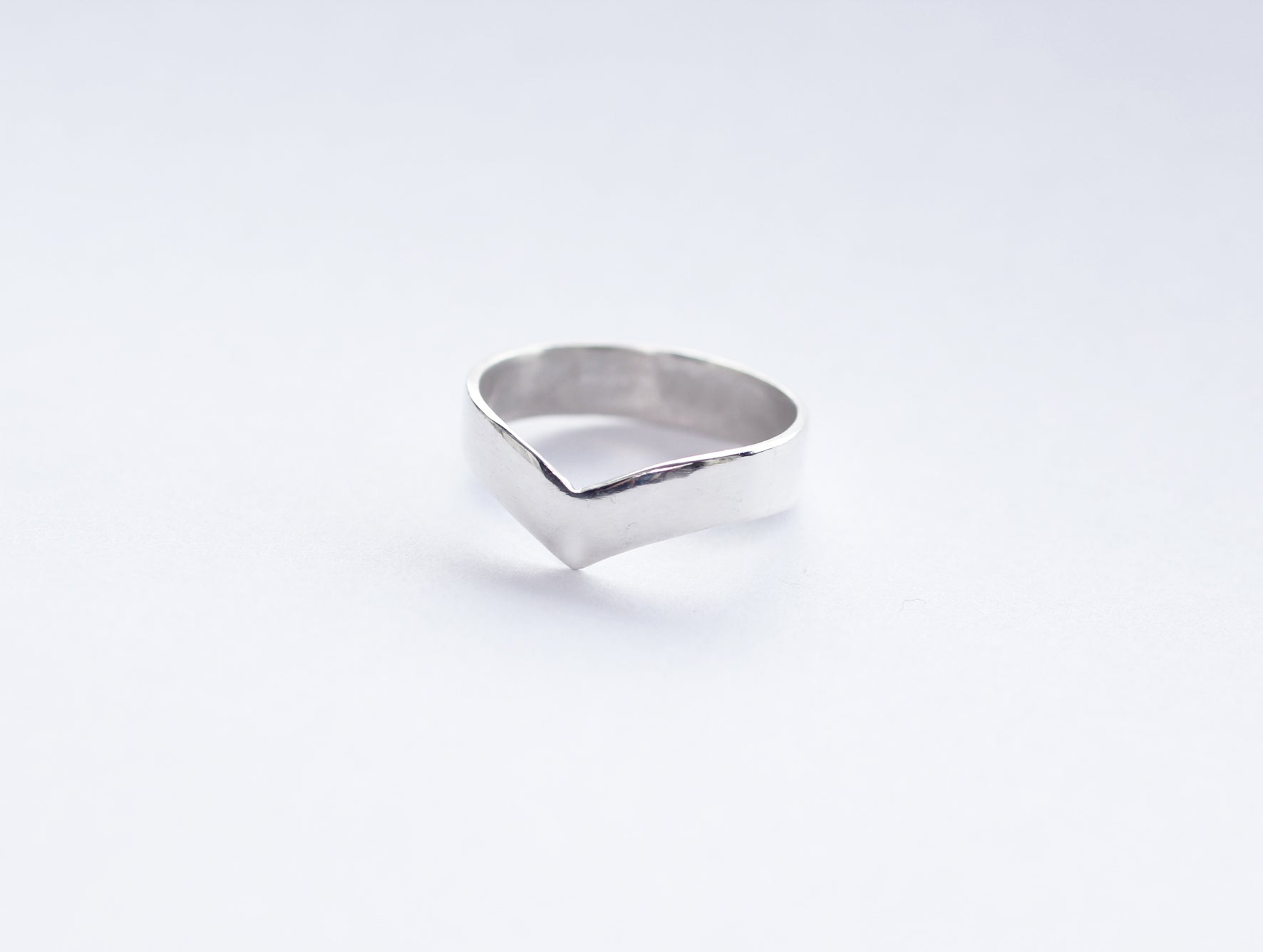 Flat-lay-Adelphi-recycled-silver-v-shaped-ring-Marie-Beatrice-Gade