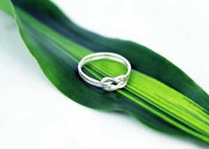 Artisan-crafted-Evighet-silver-eternity-ring-by-Marie-Beatrice-Gade-on-leaf