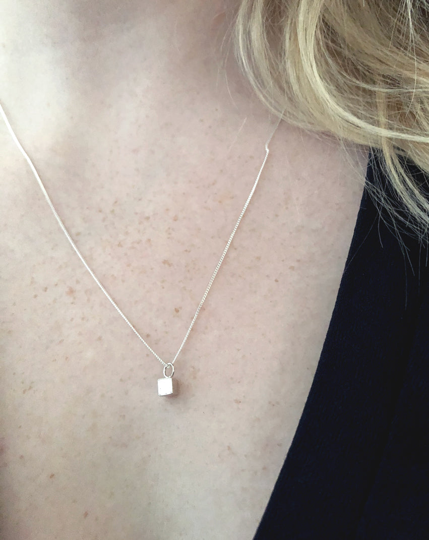 Caren-mini-silver-cube-necklace-in-recycled-925-silver-by-Marie-Beatrice-Gade-on-model