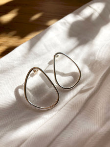 Elena-earrings-irregular-circle-shape-on-white-cotton-flatlay-by-Marie-Beatrice-Gade