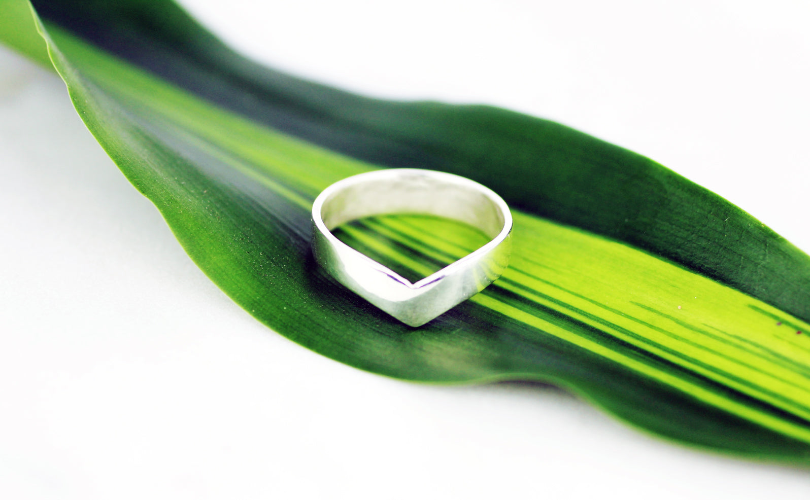 Stackable-Adelphi-v-shaped-silver-ring-by-eco-jeweller-MBG-on-leaf