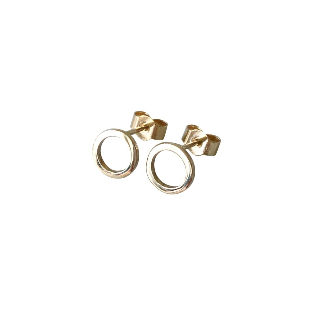 Circle gold earrings by M of Copenhagen on white background
