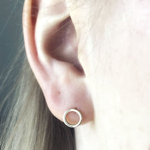 Continuum earrings in 9ct recycled gold shown on models ear