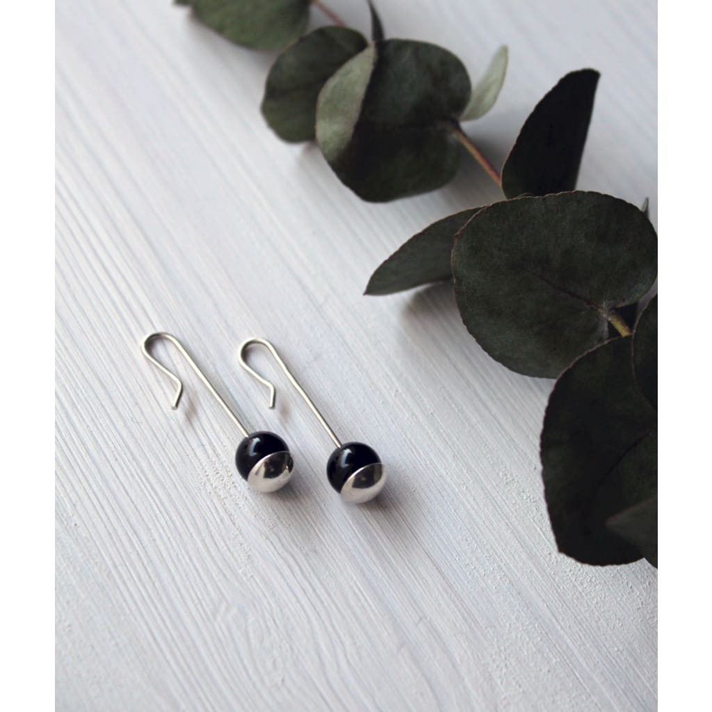 Dionne earrings by Marie Beatrice Gade made from recycled silver and natural onyx beads on wood