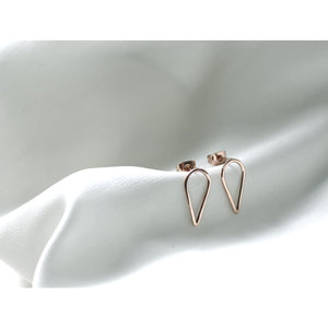 Filippa Arrow earrings in gold by M of Copenhagen on white silk