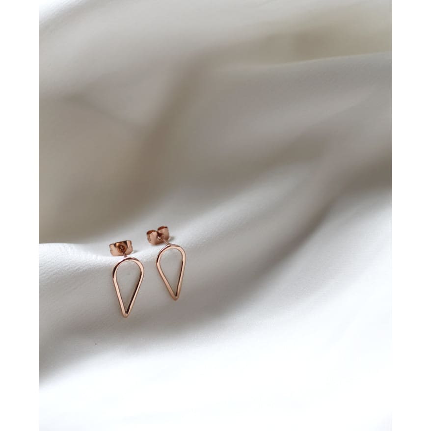 Recycled red gold teardrop shaped earrings by M of Copenhagen on white silk