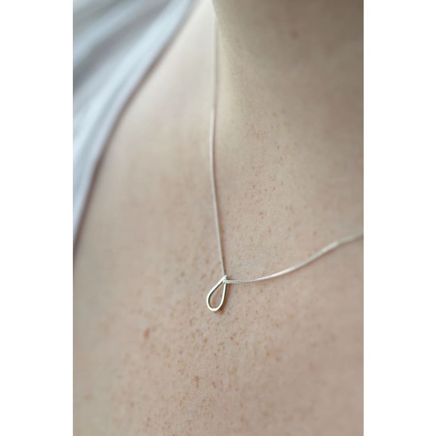 Drop shaped silver necklace by Marie Beatrice Gade shown on models neck
