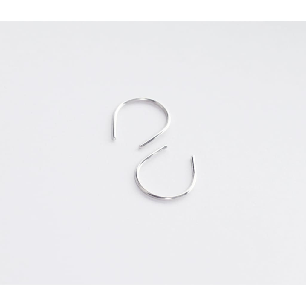 Hook recycled sterling silver earrings by eco jeweller M of Copenhagen flatlay white background