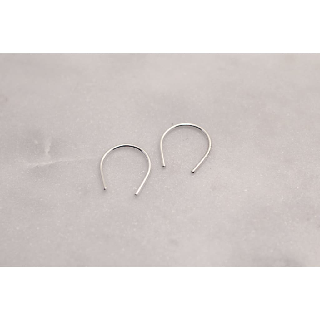 Hook minis by eco jeweller M of Copenhagen laid out on marble