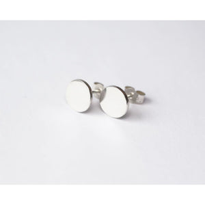 Moon earrings by M of Copenhagen with mirror finish placed on white background
