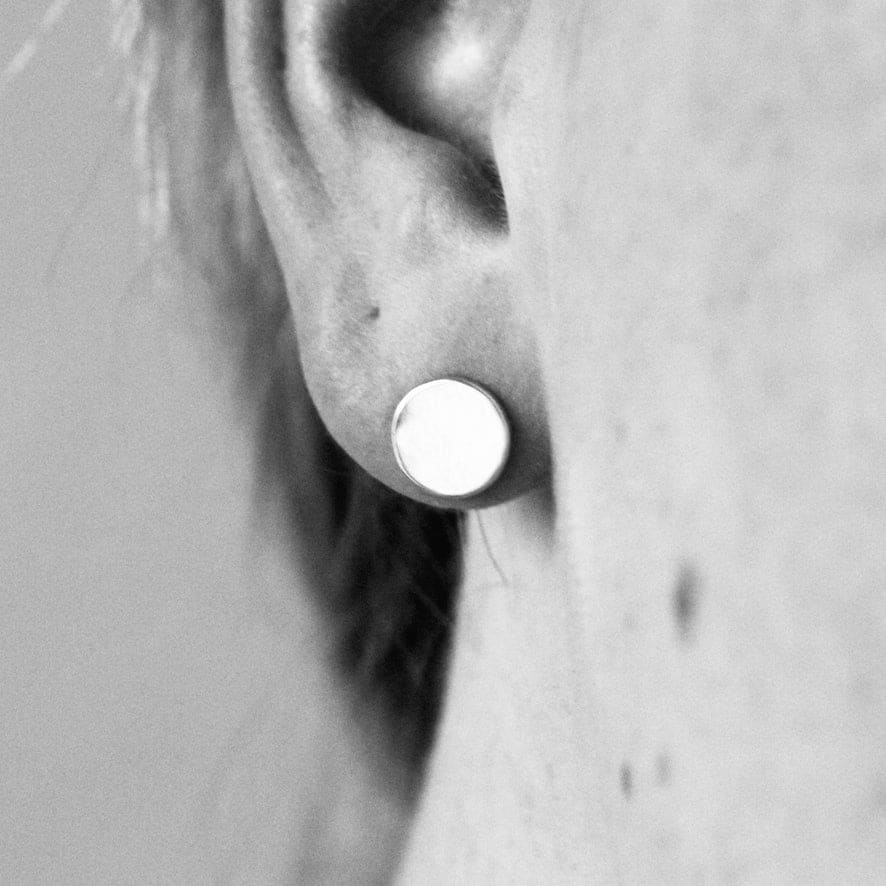 Artisan crafted Moon earrings by M of Copenhagen shown on model