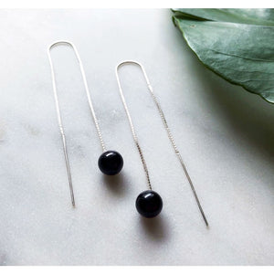 Orbit earrings by M of Copenhagen made with sterling silver and natural onyx beads