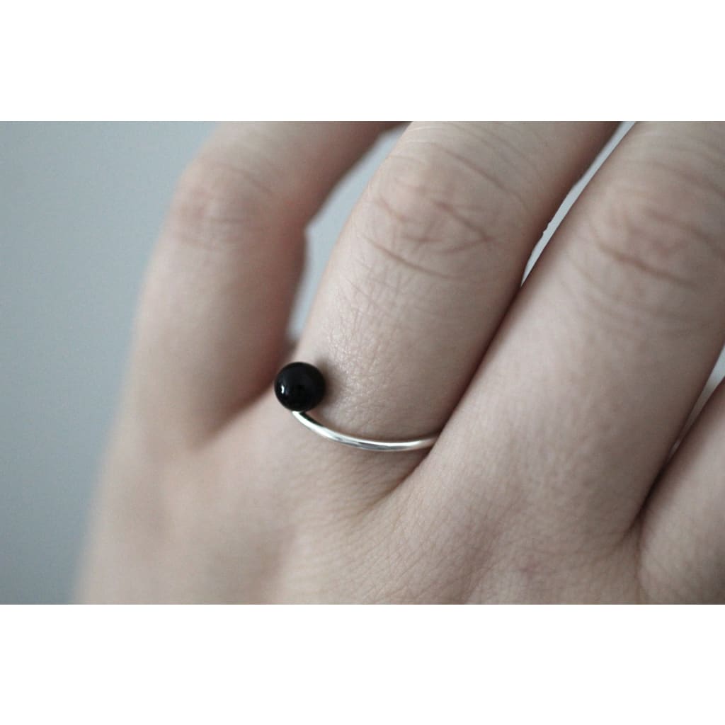 Positano ring by M of Copenhagen made with recycled silver and a natural onyx bead shown on hand