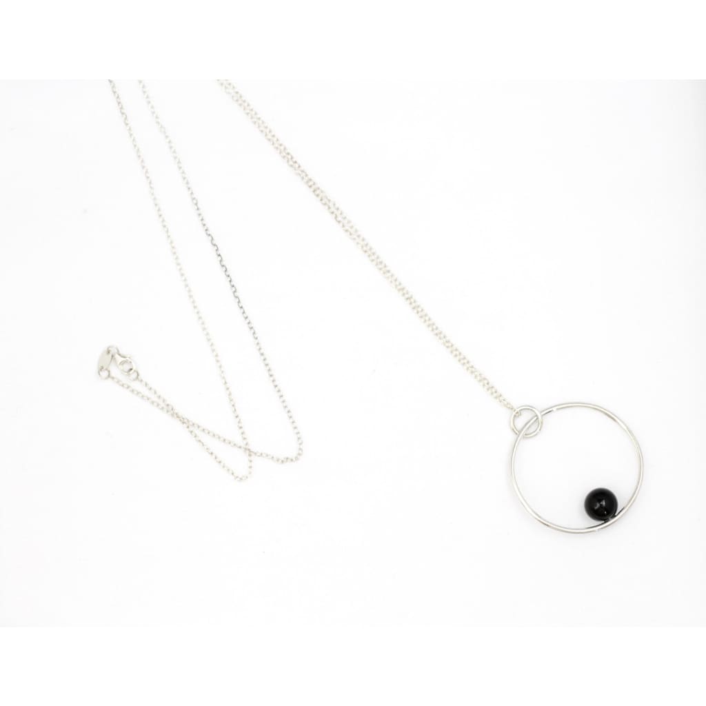 Positano necklace by M of Copenhagen made with recycled silver and onyx in flat lay