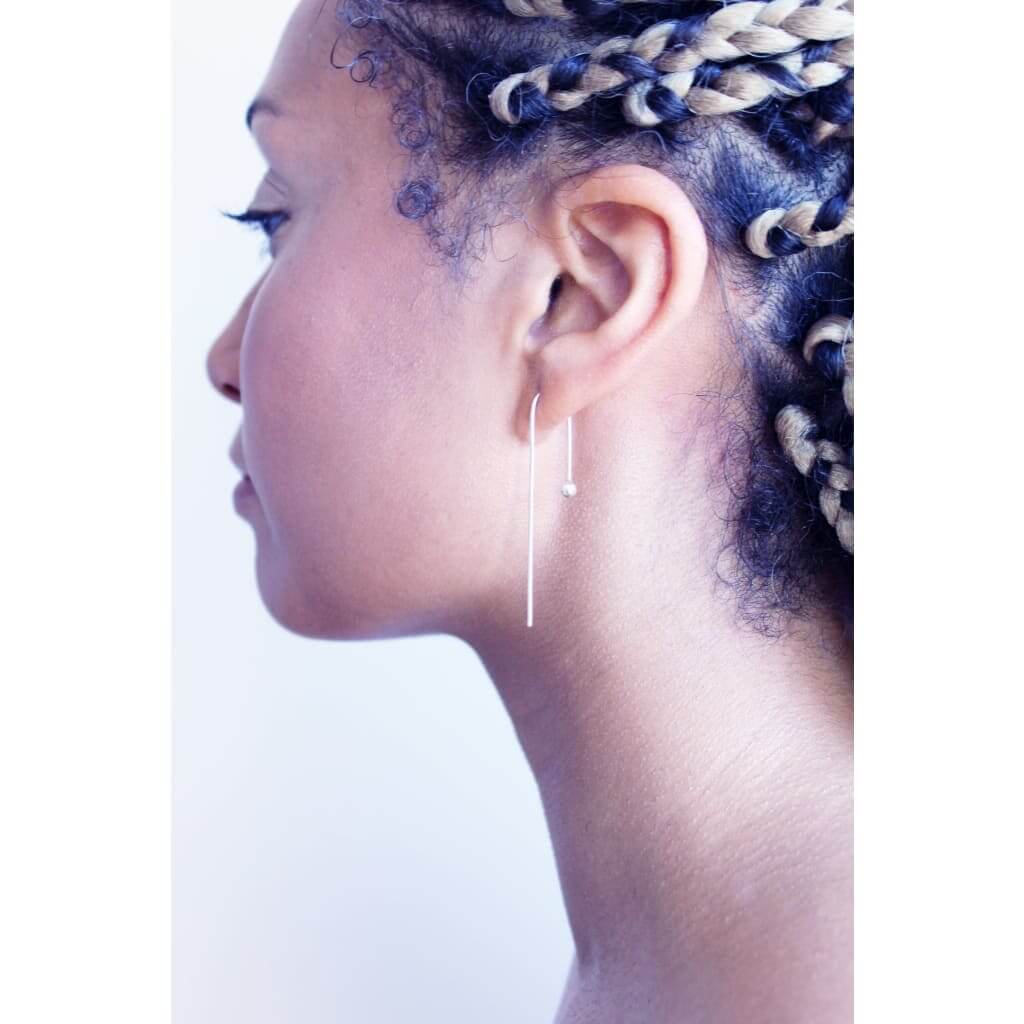 Raven earrings by M of Copenhagen made from recycled silver on model