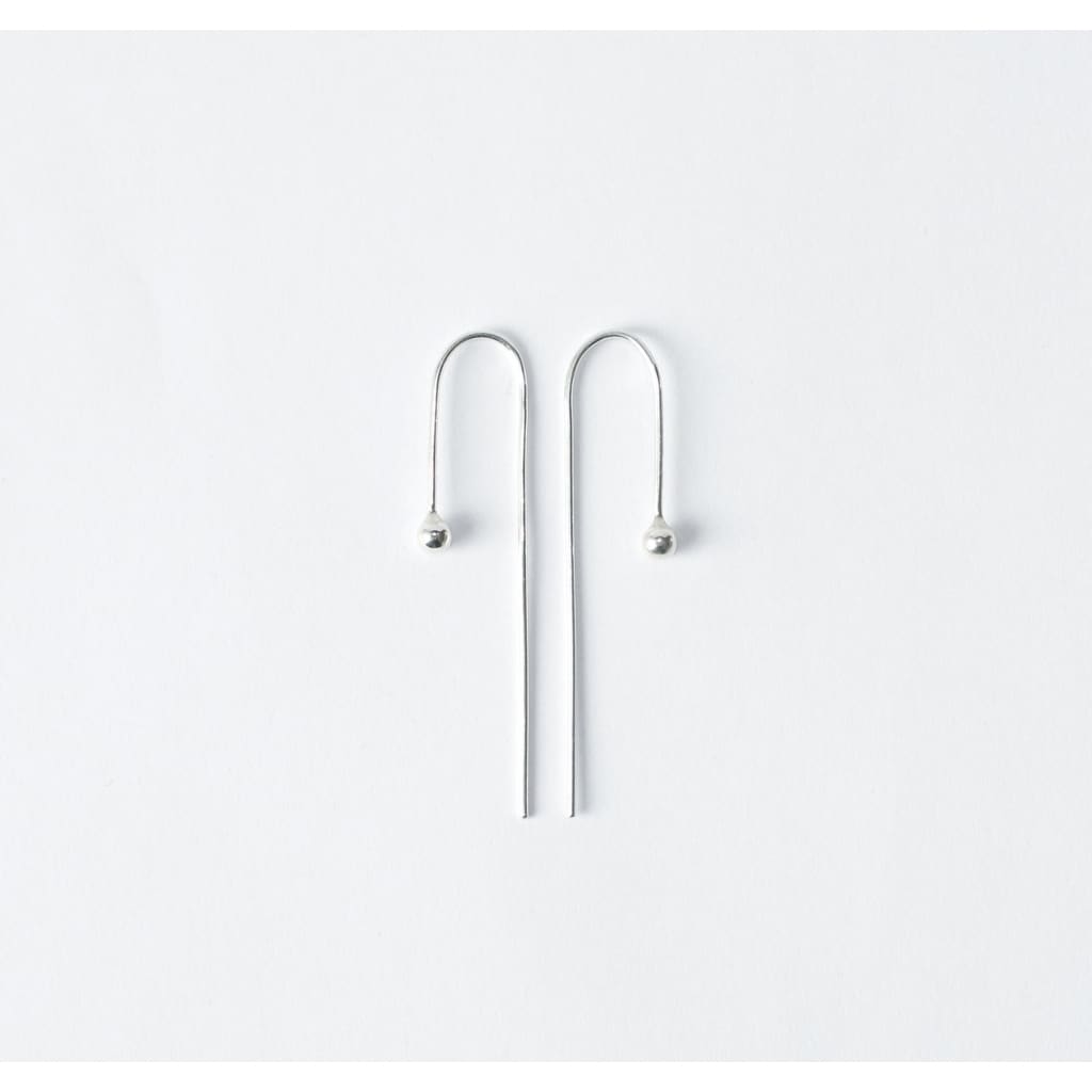 Raven earrings by M of Copenhagen made from recycled silver flat lay 