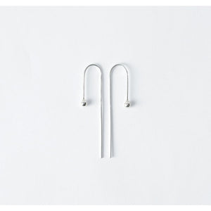 Raven earrings by M of Copenhagen made from recycled silver flat lay 
