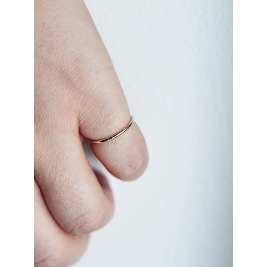 Stella stacking ring in gold by M of copenhagen on models hand
