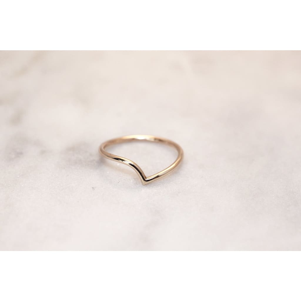 Recycled gold ring by M of Copenhagen laid out on marble