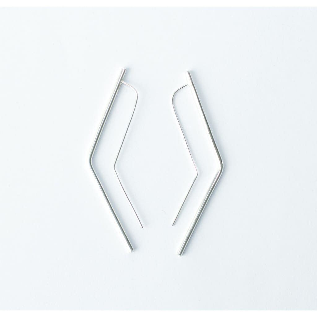 Vixen earrings by M of Copenhagen made with recycled silver flat lay on white background