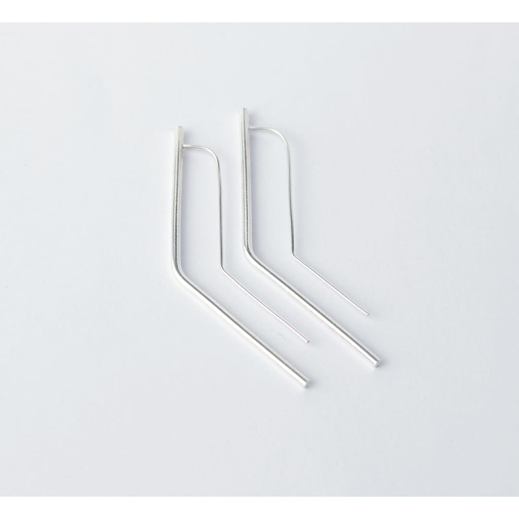 Vixen earrings by M of Copenhagen made with recycled silver flat lay on white background